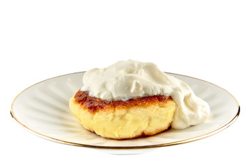 Cheesecake with sour cream in a plate on a white background, isolate