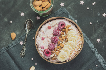 Healthy oatmeal bowl with fruits and nuts. Breakfast or dessert idea, top view flat lay