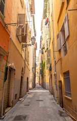 Fototapeta na wymiar colorful narrow street in Nice on french riviera, cote d'azur, south France