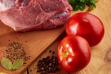 Preparation of meat dishes using tomatoes, onions and various spices.
