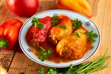 Kitchen table with food for men - stuffed peppers, rice with meat and spices.
