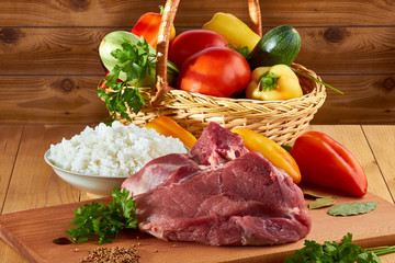 Meat dish for men, stuffed with pepper, rice with meat and spices, vegetables on the table, tasty food - energy throughout the day.