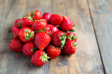 Fresh strawberries on wooden table.