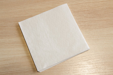 A white napkin on a wooden table