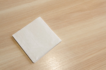 A white napkin on a wooden table