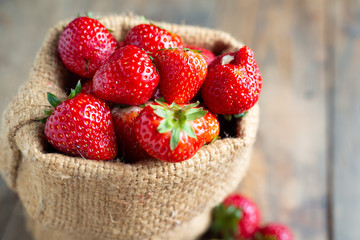 Fresh strawberries on wooden table.