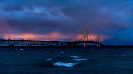 Mackinac Bridge spanning the Straits of Mackinac between the upper and lower peninsulas of Michigan, USA at sunset.