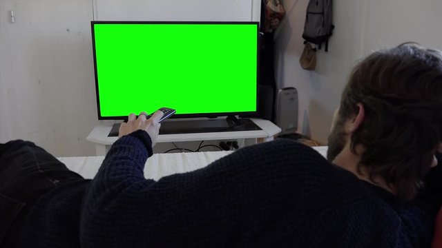 Man Changing Channel Television Lying In Bed Green Screen TV