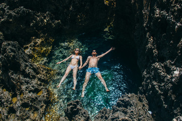 Fototapeta premium Man and woman together swim in the pool