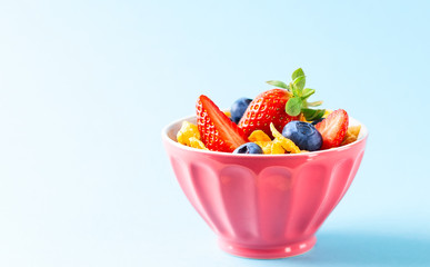 Gluten free breakfast with berries,natural yogurt and corn flakes.
