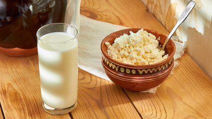 Sources of high-grade protein - cottage cheese, milk, healthy food on the morning table.