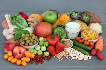Alkaline health food of vegetables, fruit, herbs, spice, milk and legumes on grey wood table background.. High in omega 3, antioxidants, anthocyanins, fibre and vitamins.