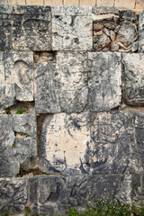 Detail of the bas-relief carved figures in the stone at the base of the Great Ball Court walls on the grounds of the Maya Ruins of Chichen Itza