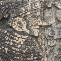 Detail of the bas-relief carved figures in the stone at the base of the Great Ball Court walls on the grounds of the Maya Ruins of Chichen Itza