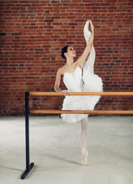 propper ballet technique.full length photo. attractive girl shows developpe, dancer reached the air