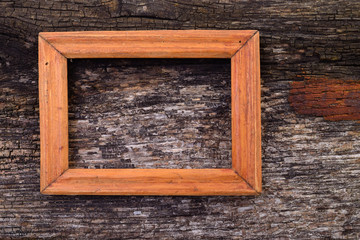 Wooden frame on wood table background.