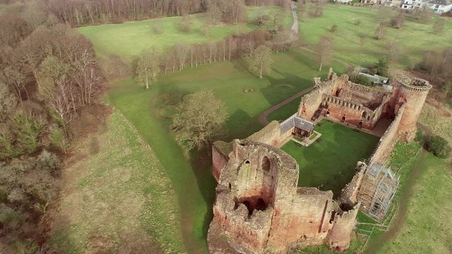 Aerial footage of Bothwell Castle near Uddingston in Scotland. Dramatic location by a winding curve in the River Clyde.