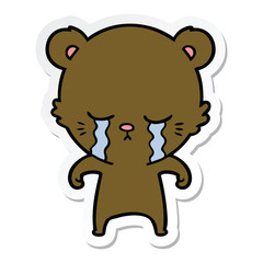 sticker of a crying cartoon bear