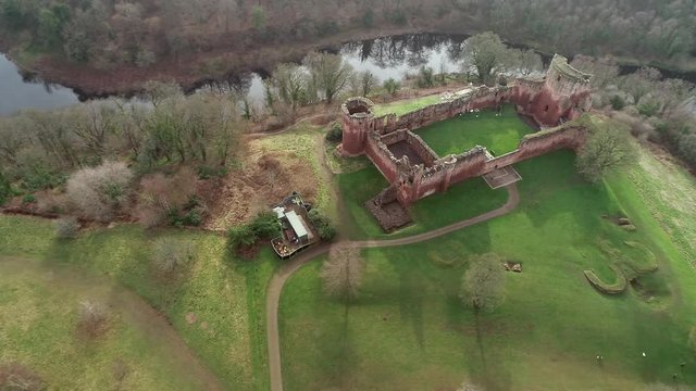 Aerial footage of Bothwell Castle near Uddingston in Scotland. Dramatic location by a winding curve in the River Clyde.