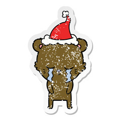 crying distressed sticker cartoon of a bear wearing santa hat