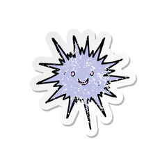 retro distressed sticker of a cartoon sea urchin