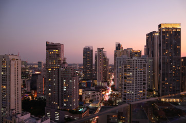 Fototapeta na wymiar Skyscrapers view of Bangkok downtown after the sunset as seen from rooftop terrace