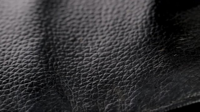 Close up of scissors being pulled out of a leather pouch by a hairstylist. Grooming and glamour equipment close up. Professional salon hand tools. 