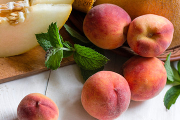 a bunch of ripe peaches with chopped melon close