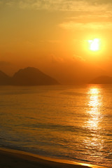 Vertical image of breathtaking sunrise over the Atlantic ocean view from Copacabana beach, Rio de Janeiro, Brazil