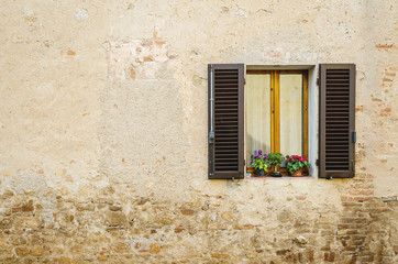 old window with shutters and flowers