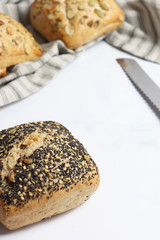 Freshly baked square shaped buns with seeds