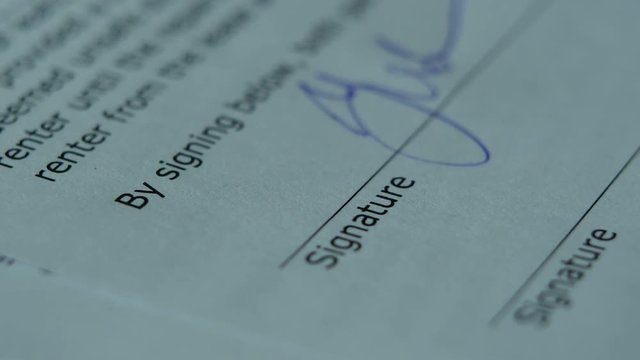 The Man Signs The Document With His Signature. Fake signature. Fake Document. 