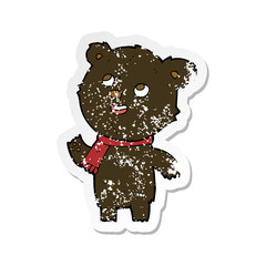retro distressed sticker of a cartoon black bear wearing scarf
