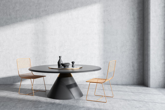 Concrete dining room with round table