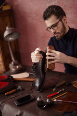 awesome shoeshine man working at home, close up photo