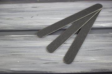 Three nail files on a gray background