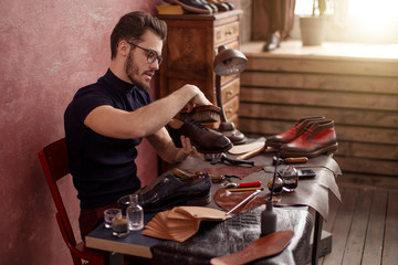 handsome guy using a shoe brush. side view photo