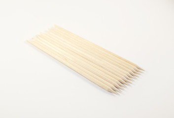 Orange wood stick cuticle pusher isolated on white