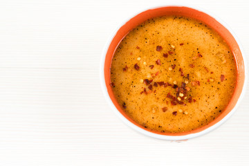 Close up image of traditional and very popular in east and south Europe soup from beef tripe on white rustic wooden background. / iskembe, kelle, paca corbasi. Top view.