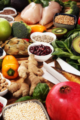 Healthy food clean eating selection. fruit, vegetable, seeds, superfood, cereals, leaf vegetable on rustic background