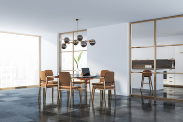White dining room corner with brown chairs
