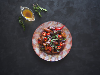 Moroccan Beef Tagine with date sauce on black. 