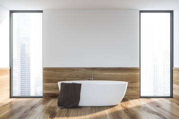 White and wooden loft bathroom with tub