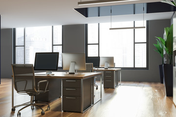 Gray open space office with windows