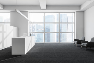 White office with reception desk and lounge