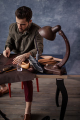 shoemaker preparing fabric for making a trendy shoes, close up photo