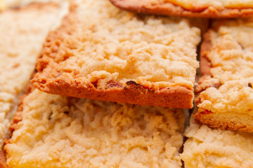 Freshly baked sand cake cut into pieces lie on top of each other