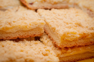 Freshly baked sand cake cut into pieces lie on top of each other