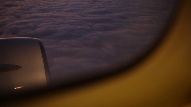 View from out window of airplane at beautiful peaceful sunset or sunrise sky. Real time full hd video footage.