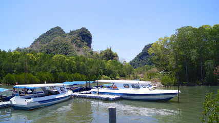 KUAH, LANGKAWI, MALAYSIA - APR 07th, 2015: tourists ride speed boat to visit mangroves at KILIM Geoforest park of Langkawi island